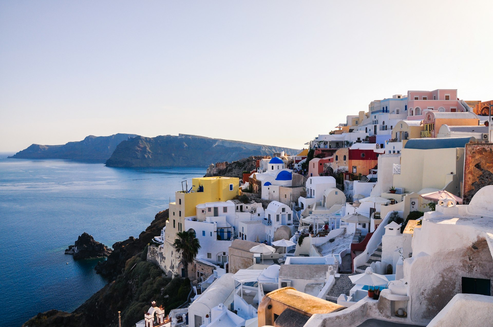white and brown concrete houses near body of water during daytime