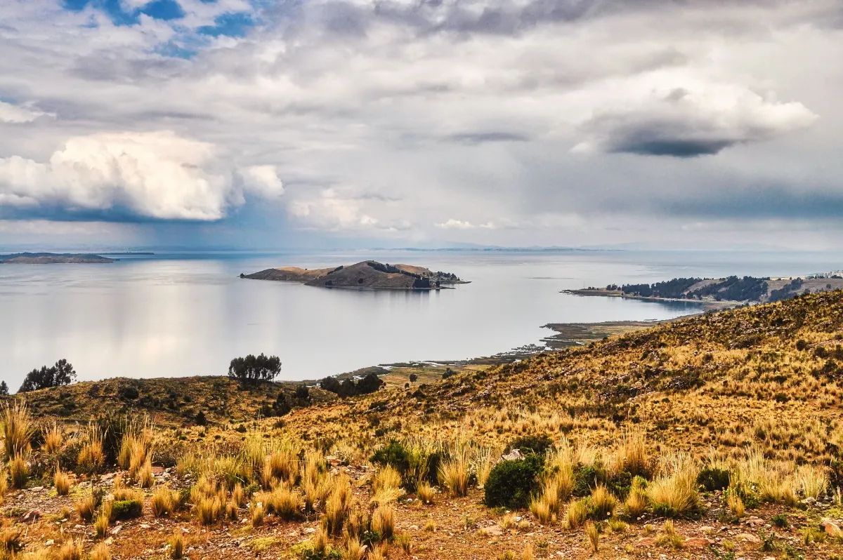 Paysage à couper le souffle du lac Titicaca avec une vue sur des îles lointaines sous des ciels dramatiques.